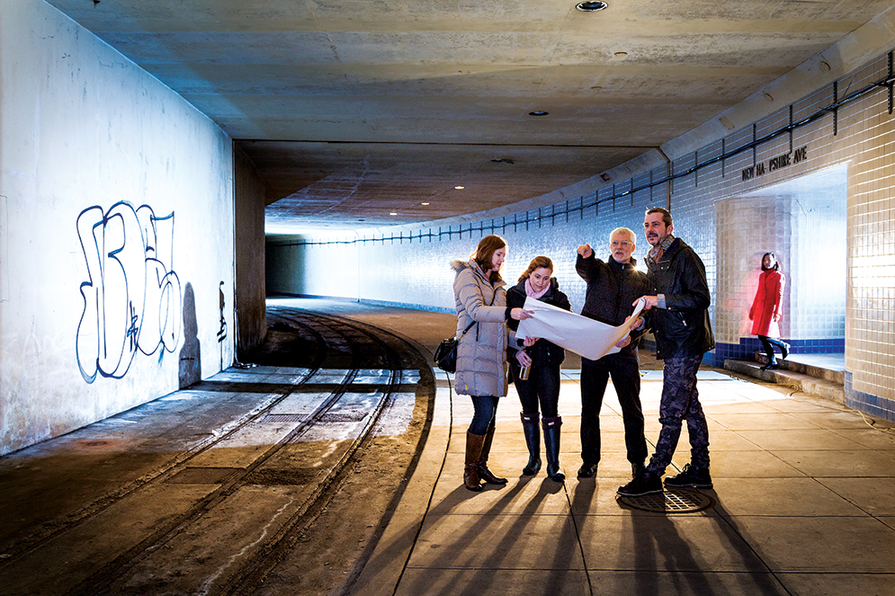 The team studying plans on the old streetcar platform beneath Dupont Circle